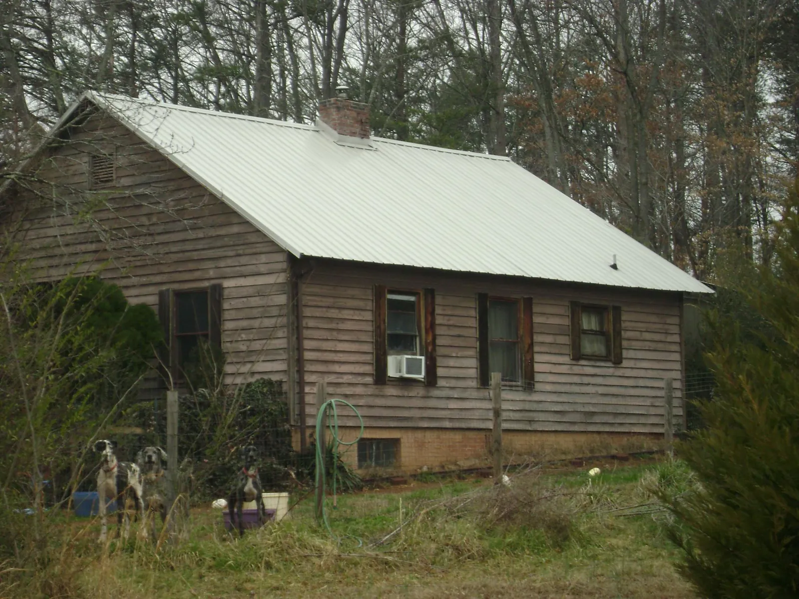 White metal roof on an old wood sided farmhouse, from a Metal Roof Installation job in Hilton Head Island